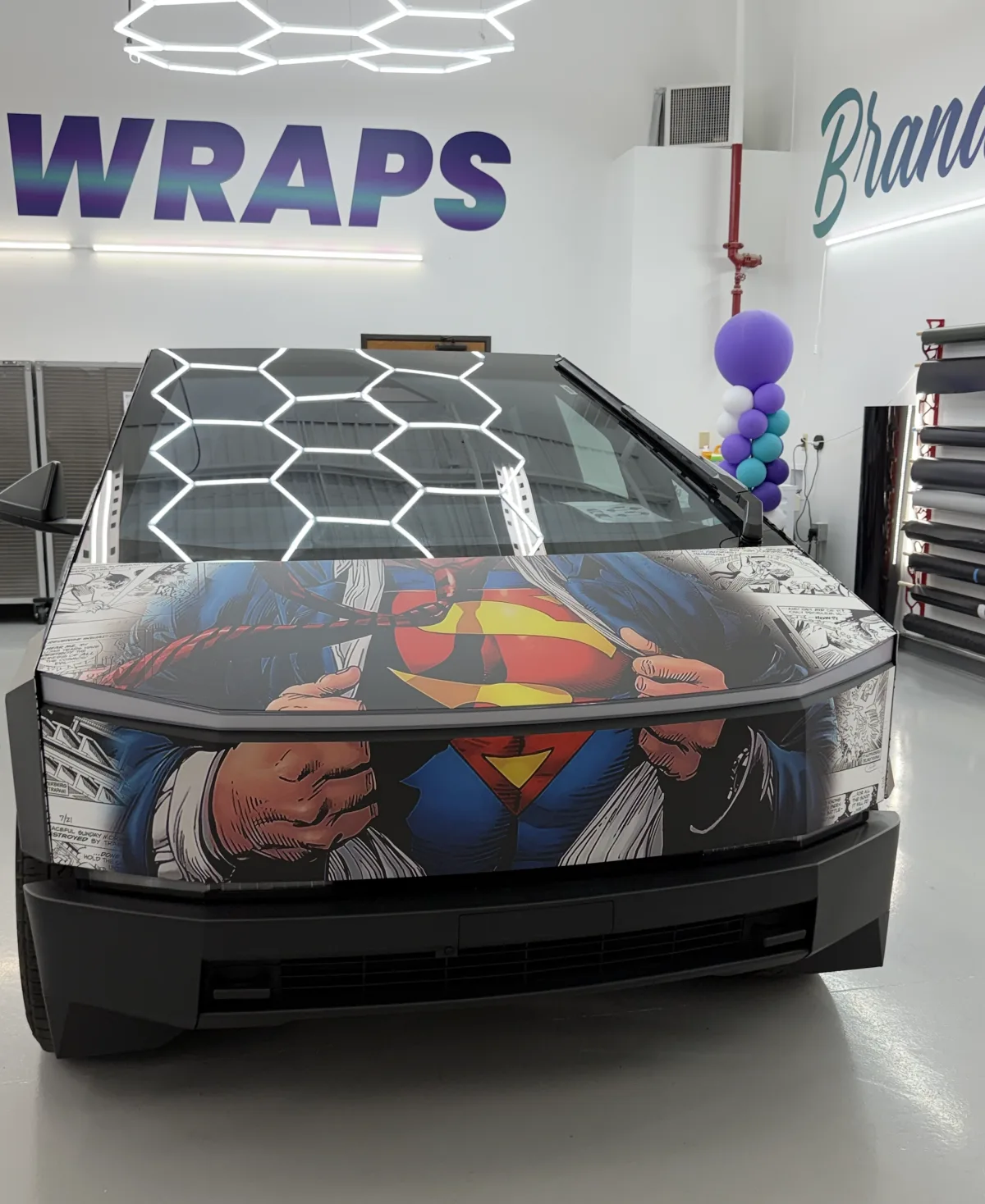 The front of the Cybertruck showing Clark Kent pulling his shirt open to reveal the Superman crest